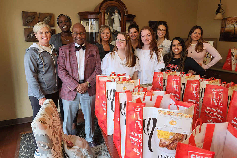 Members of the Wegmans School of Nursing and Mt. Olivet Baptist Church packed Thanksgiving baskets for families in Rochester.