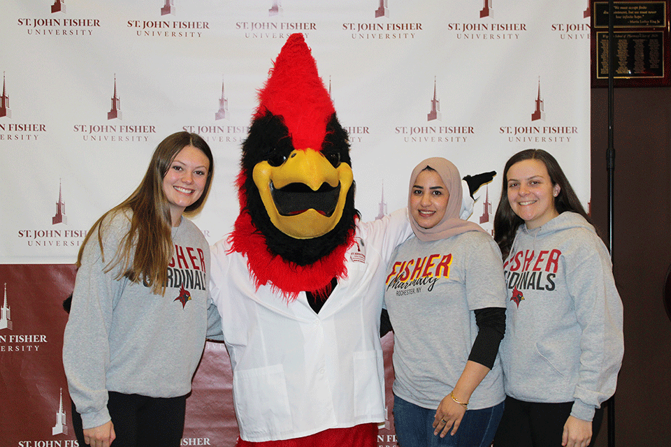 Pharmacy students pose with Cardinal at the Pharmacy Week celebration event.