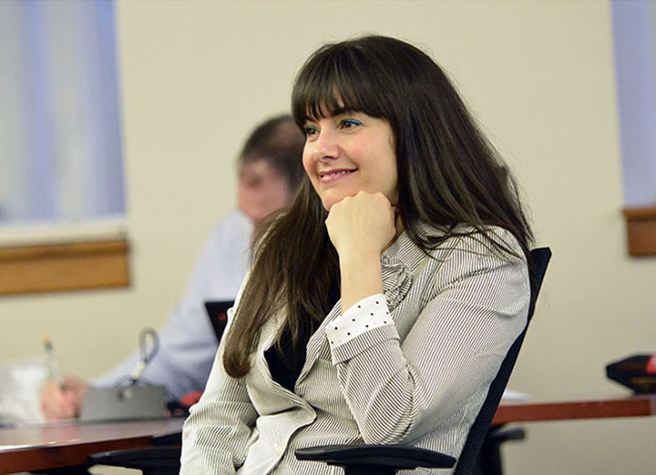 Adult student smiles in class.