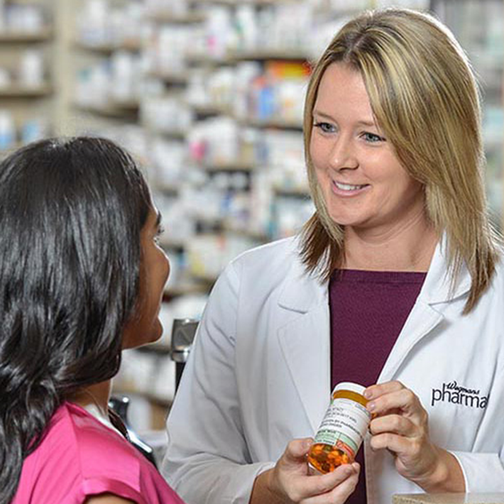 A Wegmans pharmacist speaks with a patient about a medication