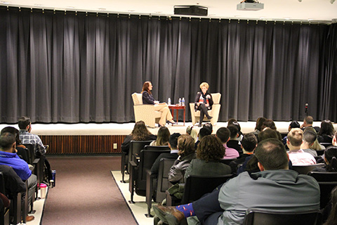 Event in Basil Auditorium with several people seated facing a stage.