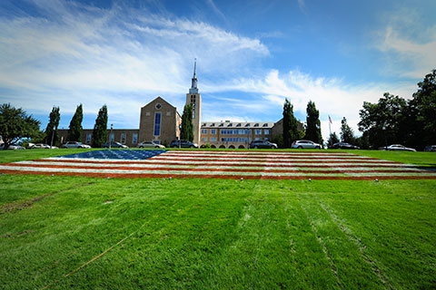 Kearney Hall with American flag painted on the lawn