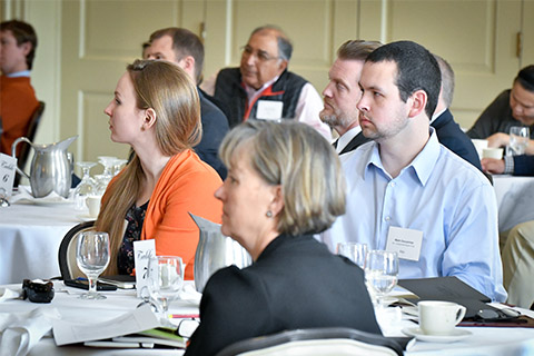 Participants listen to a speaker at a Family Business Initiative event